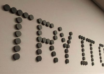 Laser cut acrylic dots used as wall signs